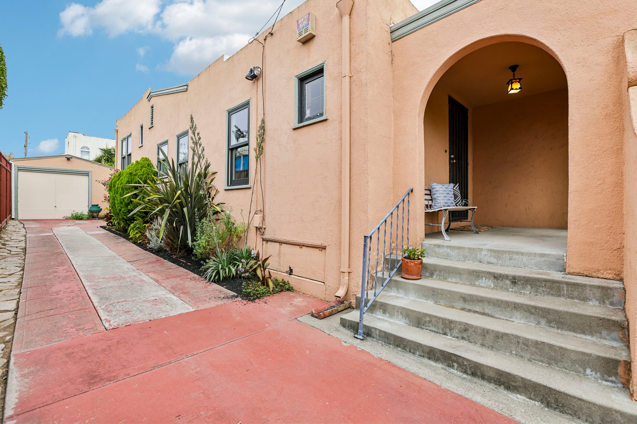 2927 58th Ave, Oakland: entry steps and arched doorway, garage down the driveway
